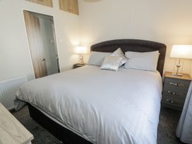 A bedroom with a bed and nightstand at Number 42 in Wemyss Bay