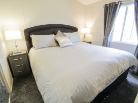 A bedroom with a bed and nightstand at Number 42 in Wemyss Bay