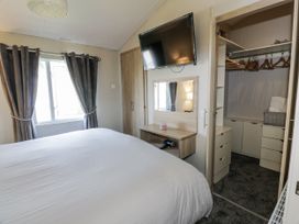 A bedroom with a bed and a wardrobe at Number 42 Wemyss Bay