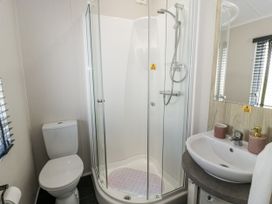 A bathroom with a toilet, shower, and sink at Number 42 Wemyss Bay