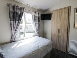 A bedroom with a bed and a window at Number 42 in Wemyss Bay