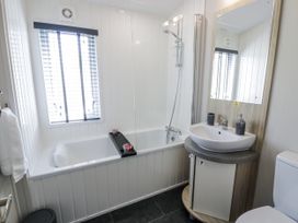 A bathroom with a bathtub and sink at Number 42 in Wemyss Bay