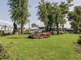 A garden area with trees and flower bed at Number 42 in Wemyss Bay