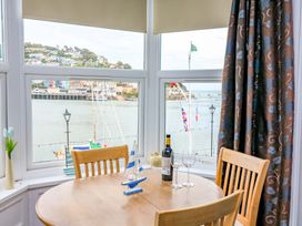 A dining room with a table and chairs at Castleview Apartment, 21 South Embankment Dartmouth
