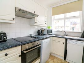 A kitchen with appliances and cabinets at Castleview Apartment, 21 South Embankment in Dartmouth