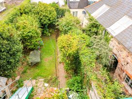 A garden with a pathway and table at Castleview Apartment, 21 South Embankment, Dartmouth