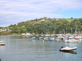 A marina with boats on water and hills in the background at Castleview Apartment, 21 South Embankment, Dartmouth