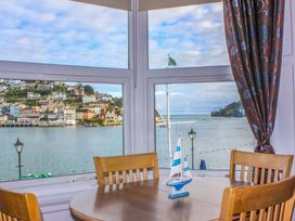 A dining room with a view of the waterfront at Castleview Apartment, 21 South Embankment, Dartmouth