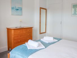 A bedroom with a bed and dresser at Castleview Apartment, 21 South Embankment Dartmouth