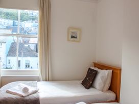 A bedroom with a bed and window at Castleview Apartment, 21 South Embankment Dartmouth