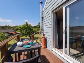 A balcony with a table set for tea at The Studio in Feock near Truro