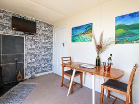 A dining room with a table and chairs at The Studio in Feock near Truro