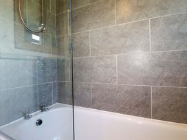 A bathroom with a bathtub and shower at The Studio in Feock near Truro