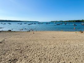 A beach scene with boats on water at The Studio in Feock near Truro