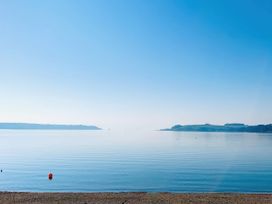 A view of calm water with a buoy at The Studio in Feock near Truro