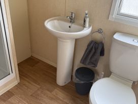 A bathroom with a sink and toilet at Chamki Lodge in Whitley Bay