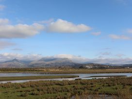 A landscape showing mountains and water at The Cottage On The Green in Porthmadog