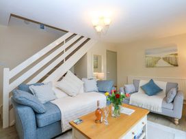 A living room with a sofa and coffee table at The Cottage On The Green Borth-Y-Gest
