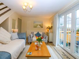 A living room with a sofa and armchairs at The Cottage On The Green Borth-Y-Gest