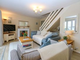 A living room with a sofa and television at The Cottage On The Green Borth-Y-Gest