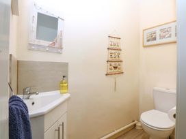 A bathroom with a sink and toilet at The Cottage On The Green Borth-Y-Gest