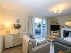 A living room with a sofa and a coffee table at The Cottage On The Green in Borth-Y-Gest
