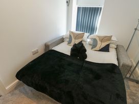 A bedroom with a bed and pillows at Rhows in Niwbwrch (Newborough)