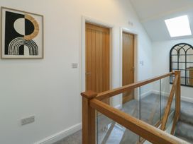 A hallway with doors and a skylight at Rhows, Niwbwrch (Newborough)