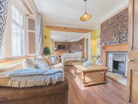 A living room with sofas a wooden coffee table and a fireplace at 1 Cleator Gate in Cleator