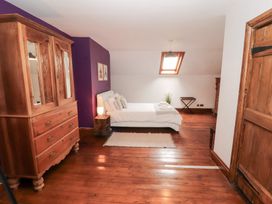 A bedroom with a bed and wardrobe at 1 Cleator Gate in Cleator