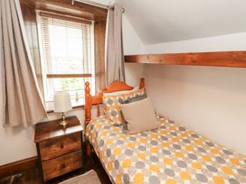 A bedroom with a bed and nightstand at 1 Cleator Gate in Cleator