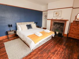 A bedroom with a bed and bedside tables at 1 Cleator Gate, Cleator