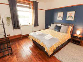 A bedroom with a bed and bedside table at 1 Cleator Gate in Cleator
