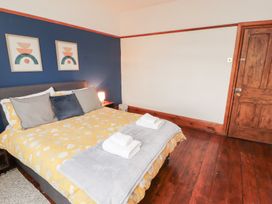 A bedroom with a bed and wall art at 1 Cleator Gate in Cleator