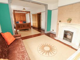 A living room with a bed and fireplace at 1 Cleator Gate in Cleator
