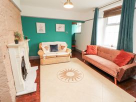 A living room with furniture and wall decor at 1 Cleator Gate in Cleator