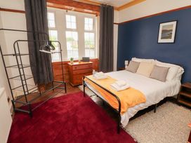 A bedroom with a bed and dresser at 1 Cleator Gate in Cleator