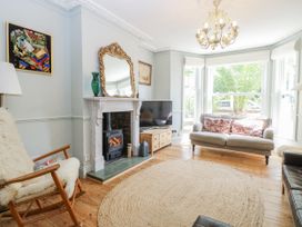 A living room with a fireplace and a sofa at 18 Pakefield Road in Lowestoft