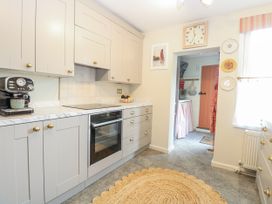 A kitchen with cabinets and a coffee maker at 18 Pakefield Road in Lowestoft
