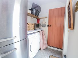 A laundry room with appliances at 18 Pakefield Road in Lowestoft