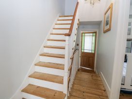 A hallway with stairs and a front door at 18 Pakefield Road in Lowestoft