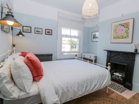 A bedroom with a bed and pictures on the wall at 18 Pakefield Road Lowestoft