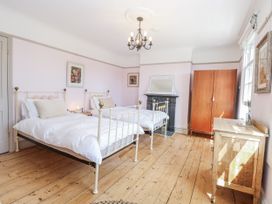 A bedroom with two beds and a wardrobe at 18 Pakefield Road in Lowestoft