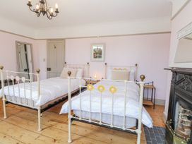 A bedroom with two beds and a fireplace at 18 Pakefield Road in Lowestoft