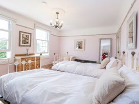 A bedroom with two beds and a dresser at 18 Pakefield Road in Lowestoft