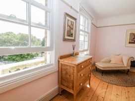 A living room with a window and wooden drawer unit at 18 Pakefield Road in Lowestoft