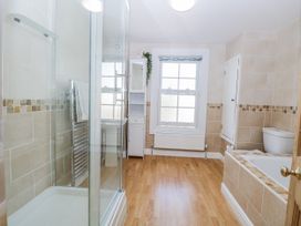 A bathroom with a shower, bathtub, and sink at 18 Pakefield Road in Lowestoft