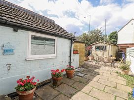 A garden with flower pots and a shed at 18 Pakefield Road in Lowestoft