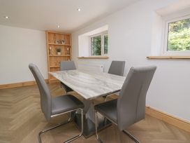 A dining room with a table and chairs at Old Post Office Cottage Ulverston