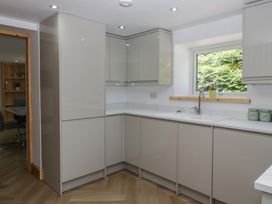 A kitchen with cabinets and sink at Old Post Office Cottage in Ulverston
